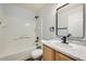 Full bathroom featuring shower and tub, wooden cabinets, and a granite countertop at 19046 E 57Th Pl # B, Denver, CO 80249