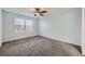 Bright bedroom with a large window, neutral carpet, and plenty of natural light at 19046 E 57Th Pl # B, Denver, CO 80249
