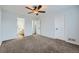 Spacious bedroom features neutral carpet, ceiling fan, and ensuite bath access at 19046 E 57Th Pl # B, Denver, CO 80249