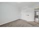 This bedroom features neutral carpet, a closet, and a spacious layout at 19046 E 57Th Pl # B, Denver, CO 80249