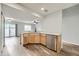 Kitchen featuring wood cabinets, wood flooring, stainless steel dishwasher and a peninsula sink at 19046 E 57Th Pl # B, Denver, CO 80249