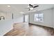 Open-concept living room with wood floors, sliding glass doors, and a large window at 19046 E 57Th Pl # B, Denver, CO 80249