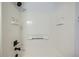 Updated shower with white tile surround, matte black shower head and fixtures at 19046 E 57Th Pl # B, Denver, CO 80249