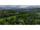 Expansive mountain view featuring a residential community nestled amongst green forests and winding roads at 24036 Currant Dr, Golden, CO 80401
