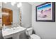 Cozy powder room features a charming stone-trimmed mirror and stylish decor at 24036 Currant Dr, Golden, CO 80401