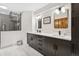 Modern bathroom with dual sinks, sleek cabinets, and a glass-enclosed shower at 24036 Currant Dr, Golden, CO 80401