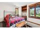 Comfortable bedroom with a cozy bed and rustic wood furnishings at 24036 Currant Dr, Golden, CO 80401