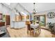 Open dining area with hardwood floors, natural light and vaulted ceilings adjacent to kitchen at 24036 Currant Dr, Golden, CO 80401