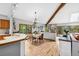 Inviting dining area with hardwood floors, exposed beam, natural light, and easy kitchen access at 24036 Currant Dr, Golden, CO 80401