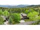 Stunning mountain home surrounded by lush trees, offering serene privacy and beautiful scenic views at 24036 Currant Dr, Golden, CO 80401