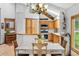 Open dining and kitchen space featuring wood cabinetry, stainless steel appliances, and natural lighting at 24036 Currant Dr, Golden, CO 80401
