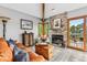 Cozy living room featuring a stone fireplace, hardwood floors, comfortable seating, and outdoor access at 24036 Currant Dr, Golden, CO 80401