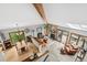 Open-concept living room with a fireplace, vaulted ceilings, and large windows for natural light at 24036 Currant Dr, Golden, CO 80401