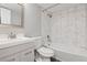 Modern bathroom featuring a vanity, toilet, and shower with elegant white marble-style tiling at 3100 S Federal Blvd # 331, Denver, CO 80236