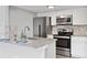 Well-lit kitchen featuring stainless steel appliances, white cabinetry and granite countertops at 3100 S Federal Blvd # 331, Denver, CO 80236