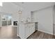 Open kitchen view with granite counters, stainless appliances, and a view into the living room at 3100 S Federal Blvd # 331, Denver, CO 80236