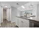 Stylish kitchen with granite countertops, modern appliances, a skylight and adjoining eat-in area at 3100 S Federal Blvd # 331, Denver, CO 80236