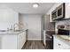 Bright kitchen featuring stainless steel appliances, white cabinets, and wood-look flooring at 3100 S Federal Blvd # 331, Denver, CO 80236