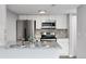 Modern kitchen featuring stainless steel appliances, granite countertops, and white cabinetry at 3100 S Federal Blvd # 331, Denver, CO 80236