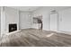 Spacious living area with an open kitchen and cozy fireplace, enhanced by modern flooring at 3100 S Federal Blvd # 331, Denver, CO 80236