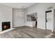 Inviting living room with open floor plan to the kitchen, stylish lighting, and stone fireplace at 3100 S Federal Blvd # 331, Denver, CO 80236