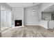 Bright living room featuring a contemporary white brick fireplace and an open layout to the kitchen at 3100 S Federal Blvd # 331, Denver, CO 80236