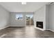 Cozy living area boasts a charming white brick fireplace, large windows, and sliding doors to outside at 3100 S Federal Blvd # 331, Denver, CO 80236