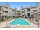 Outdoor pool with several lounge chairs and tables, ideal for enjoying the sunshine and community at 3100 S Federal Blvd # 331, Denver, CO 80236