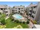 Outdoor pool area with multiple buildings surrounding it and lush landscaping, offering a relaxing environment at 3100 S Federal Blvd # 331, Denver, CO 80236