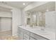Bathroom featuring double sinks, a walk-in shower, and a walk-in closet at 762 N Rome St, Aurora, CO 80018