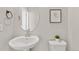 Clean powder room featuring a pedestal sink, a toilet, and a decorative mirror at 762 N Rome St, Aurora, CO 80018