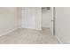 A bedroom featuring sliding closet doors and an open doorway to another room at 762 N Rome St, Aurora, CO 80018