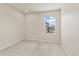 A bedroom with neutral walls and carpet, a window view, and electrical outlets at 762 N Rome St, Aurora, CO 80018