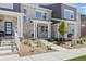 Stylish townhome featuring stone accents, well-maintained landscaping, and a welcoming covered entryway at 762 N Rome St, Aurora, CO 80018
