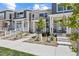 Attractive townhome featuring stone facade, covered porch, and contemporary landscaping at 762 N Rome St, Aurora, CO 80018