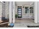 Charming front porch with sleek black door, modern sconce, and stylish stone facade at 762 N Rome St, Aurora, CO 80018
