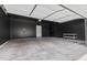 Spacious two car garage with dark walls and a solid white door at 762 N Rome St, Aurora, CO 80018