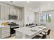 Well-lit kitchen with modern appliances, gray cabinets, and a kitchen island at 762 N Rome St, Aurora, CO 80018