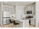 Modern kitchen featuring stainless steel appliances, island with seating, and ample cabinet space at 762 N Rome St, Aurora, CO 80018