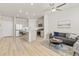 Open-concept living room and kitchen featuring a gray sofa and stainless steel appliances at 762 N Rome St, Aurora, CO 80018