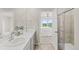 Main bathroom showcasing double sinks, a glass-enclosed shower, and modern fixtures at 762 N Rome St, Aurora, CO 80018