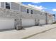 A row of townhome garages with brick, siding, and attached air conditioning units at 762 N Rome St, Aurora, CO 80018