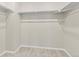 A walk-in closet featuring neutral carpet and white shelving for organized storage at 762 N Rome St, Aurora, CO 80018
