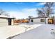 Snowy backyard with detached garage and shed in winter at 5565 W Arizona Ave, Lakewood, CO 80232