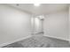 Clean, carpeted basement hallway with white walls and doors at 5565 W Arizona Ave, Lakewood, CO 80232