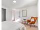 Bright bedroom with light flooring and a comfortable chair at 5565 W Arizona Ave, Lakewood, CO 80232