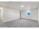 Simple bedroom with gray carpeting and a sliding door at 5565 W Arizona Ave, Lakewood, CO 80232