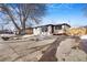Ranch home exterior with driveway and mature tree at 5565 W Arizona Ave, Lakewood, CO 80232