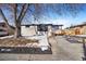 Charming ranch house with a large tree and spacious driveway at 5565 W Arizona Ave, Lakewood, CO 80232