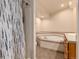 Bathroom with corner tub, shower with curtain, vanity, and plentiful lighting at 250 Upper Forest Rd, Idaho Springs, CO 80452
